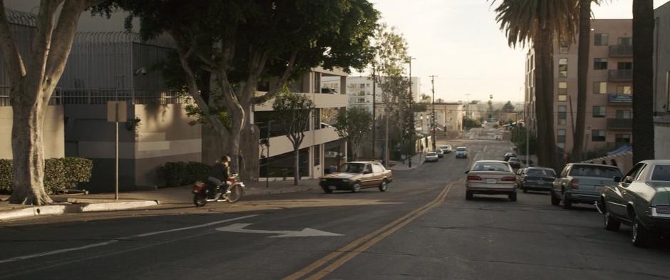 Vers drives down the street on her stolen motorcycle.