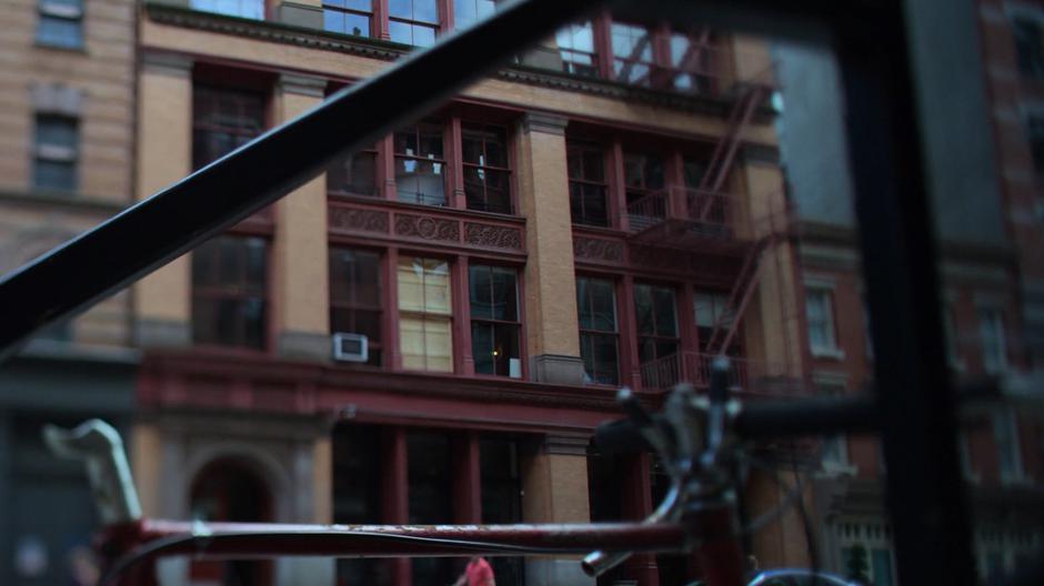 Establishing shot of the apartment building during the day.