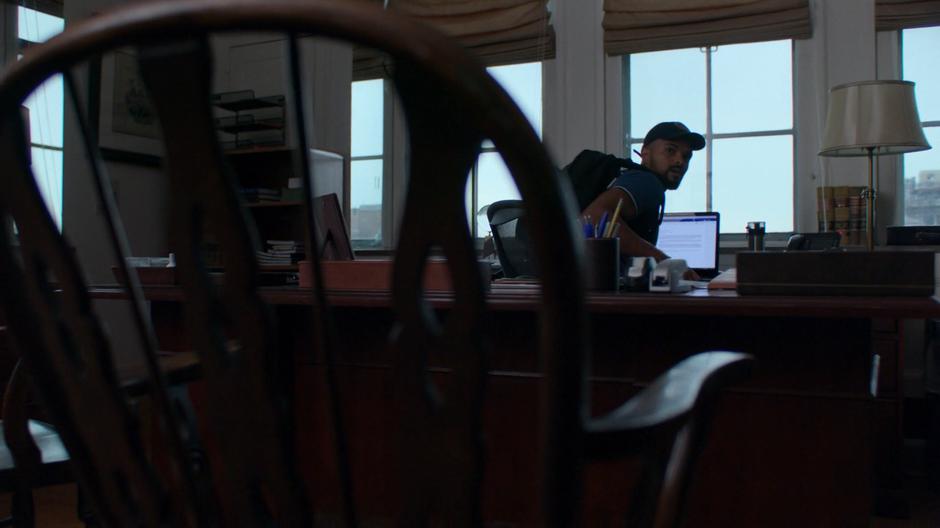 Malcolm checks over his shoulder after sitting down in front of Peter Lyonne's laptop.