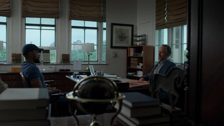 Malcolm sits down across from Peter Lyonne in his office.