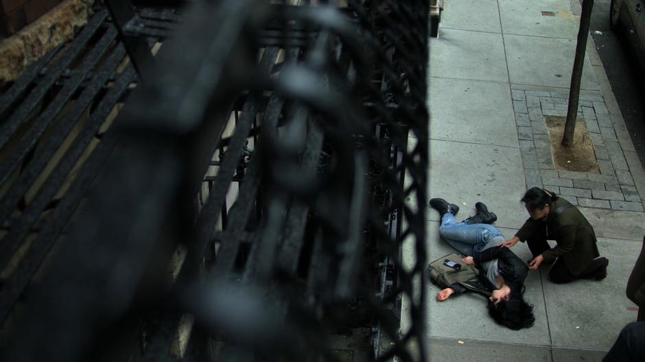 A passerby kneels down next to Jessica after Trish leaves.