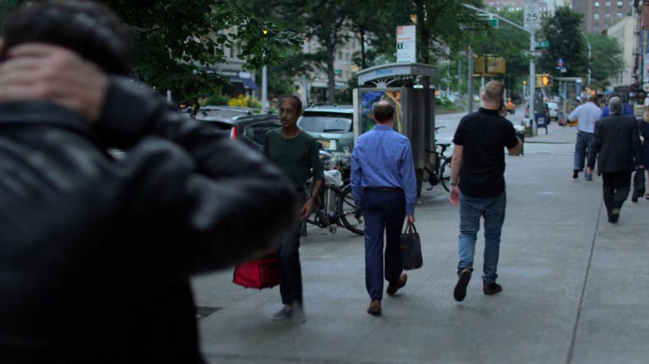 Erik rubs the back of his neck while he follows a sketchy dude down the street.