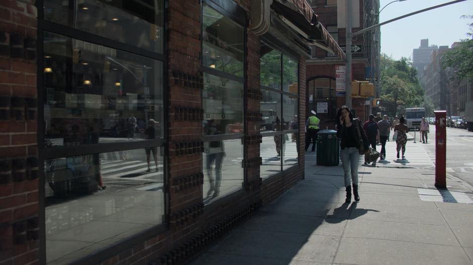 Jessica talks to Trish on the phone while walking around the corner.