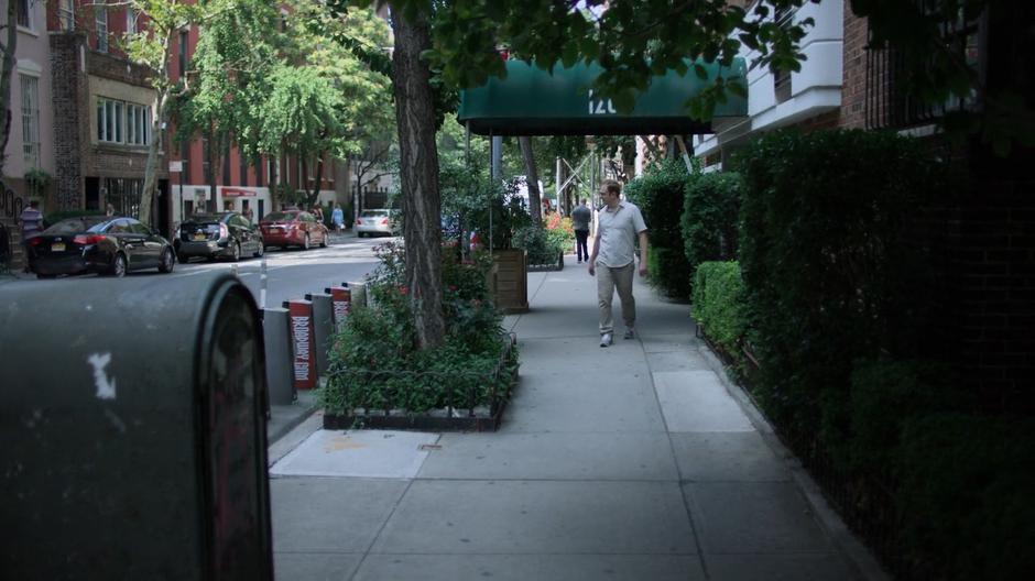 Gregory Sallinger looks around as he leaves his building.