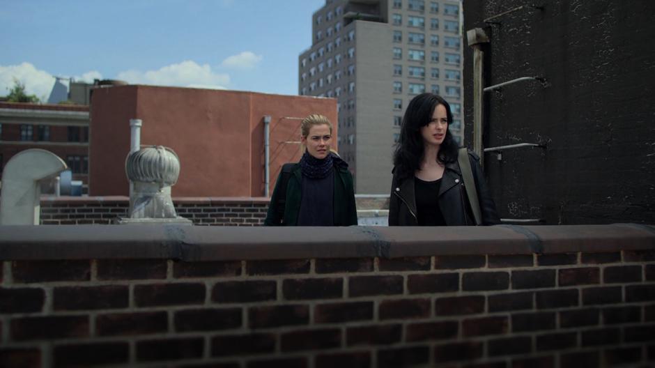 Trish and Jessica look out from the roof towards Gregory Sallinger's apartment.