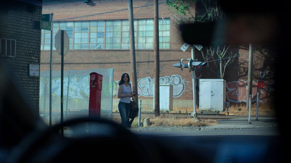 Jessica looks over as Trish gets her attention from where she is parked down the street.