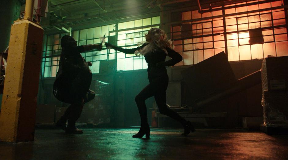 Cicada and Killer Frost fight dagger to dagger inside the factory.