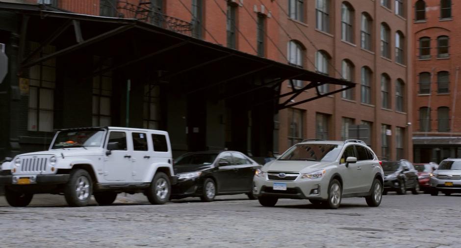 Stephanie drives down the cobblestone street.