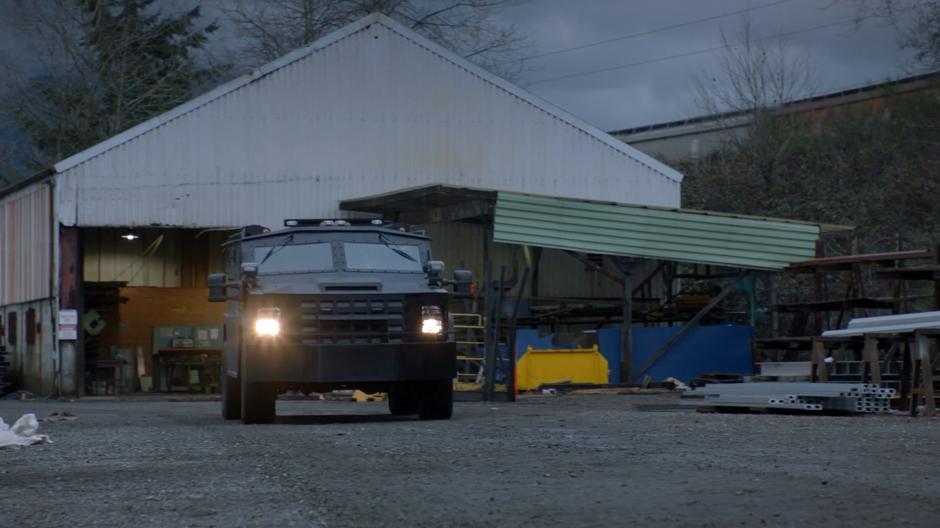 Major's armored car drives down the gravel road.