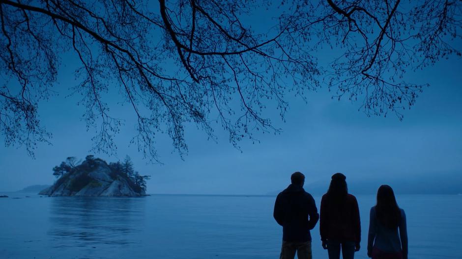 Ben, Maddie, and Ryn look out over the water at dusk.