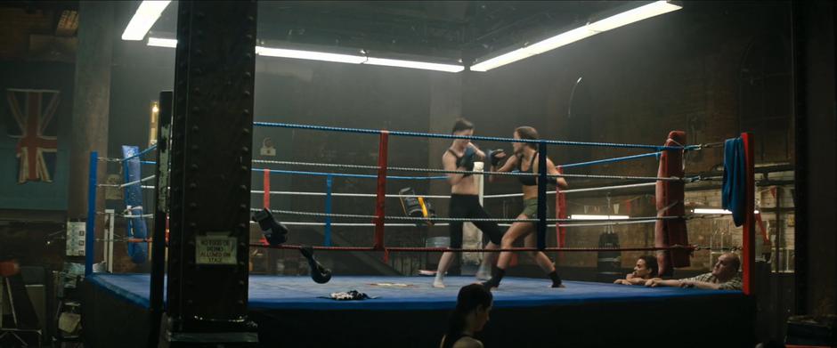 Rose and Lara spar in the ring while Sohpie and Terry watch from the edge of the ring.