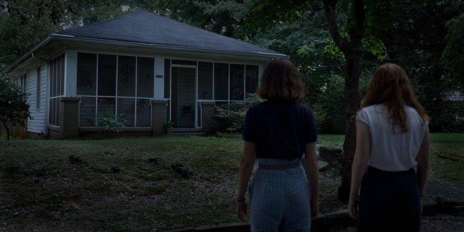 Eleven and Max stand on the street looking at the house.