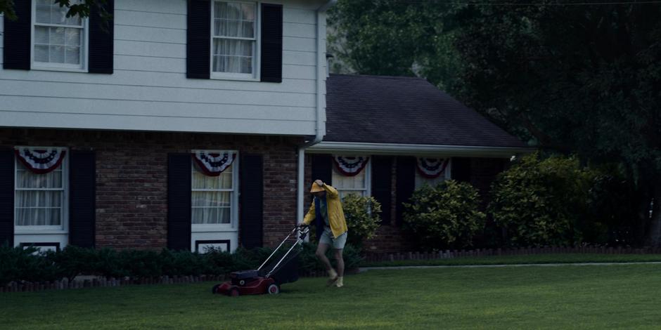 Ted Wheeler mows the lawn in the pouring rain.