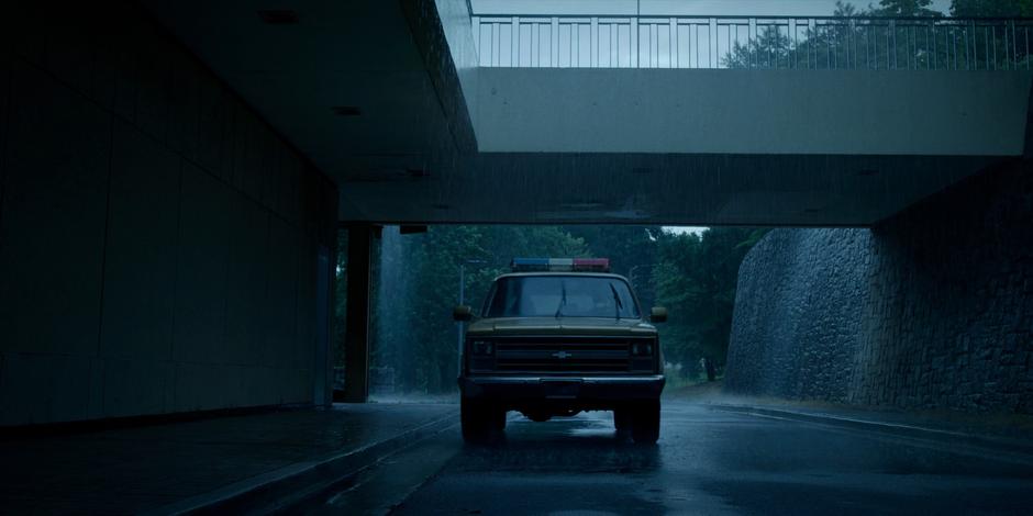 Hopper drives his truck up to the lab with Joyce in the heavy rain.