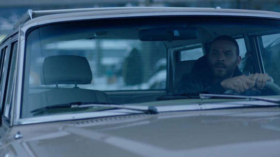 Xander waits in his car as Ben walks to the facility.