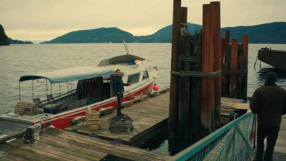 Xander walks down to the dock where Calvin is waiting by his new boat.