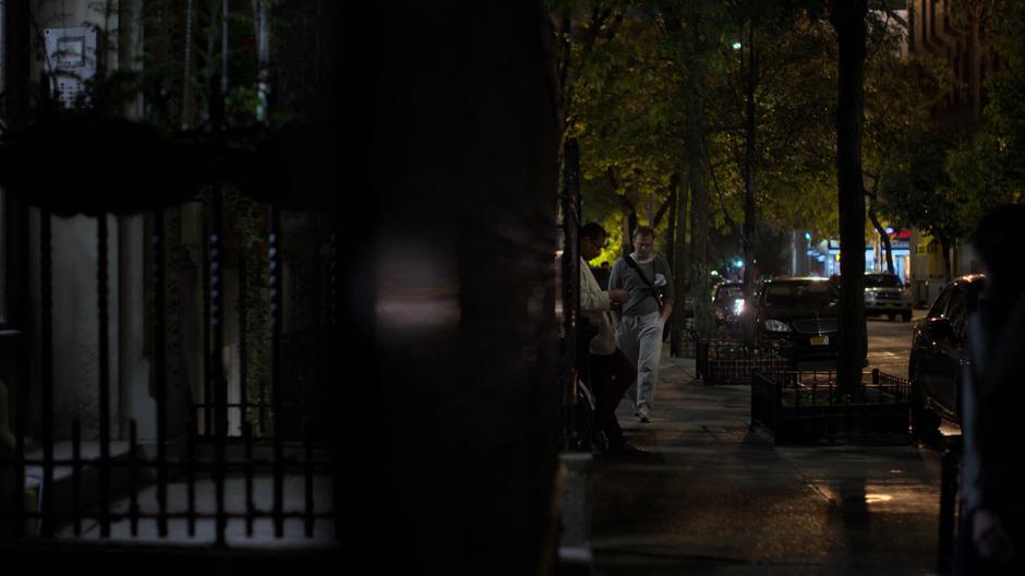 Sallinger walks down the sidewalk at night.