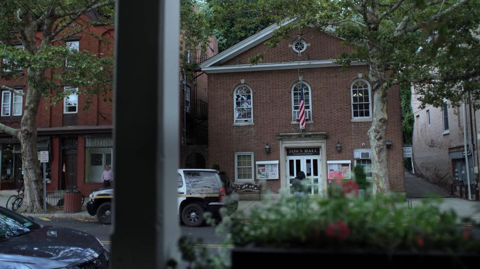 Jessica walks across the street to the town hall which contains the police station.