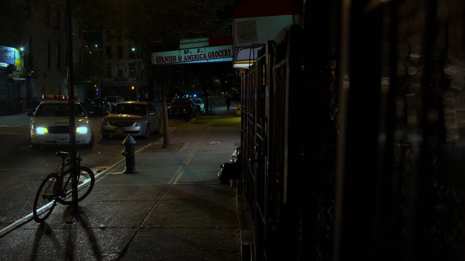 Officer Nussbaumer pulls his squad car to the curb in front of the market.