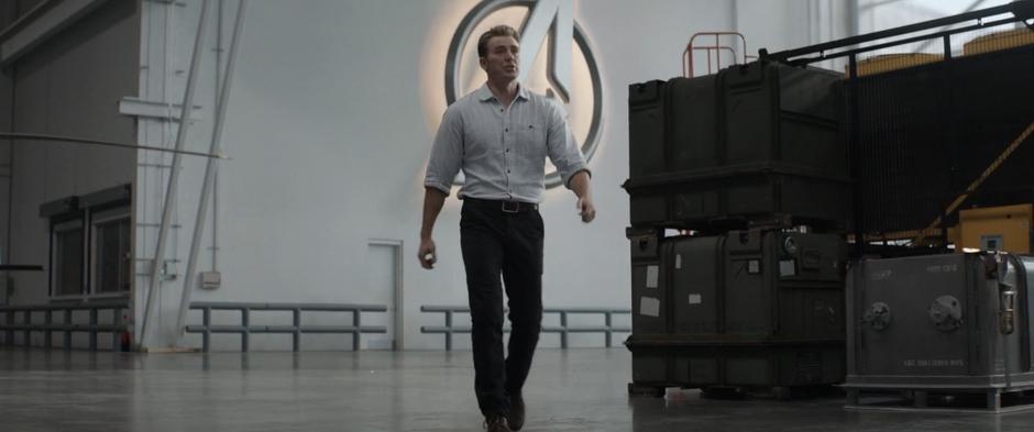 Steve walks through the warehouse to meet the others for the time travel test.