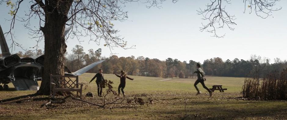 Lila and Cooper run towards Clint who has just emerged from a Quinjet.