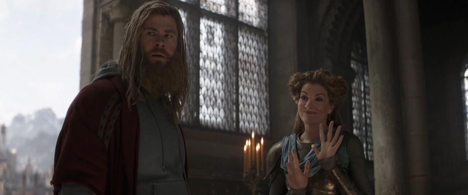 Frigga waves at Rocket as she was talking with Thor.