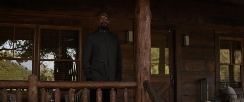 Fury stands on the deck of the cabin during Tony's funeral.