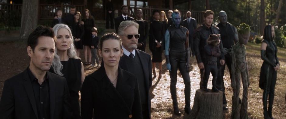 A huge group of Avengers stand at the shore during Tony's funeral.