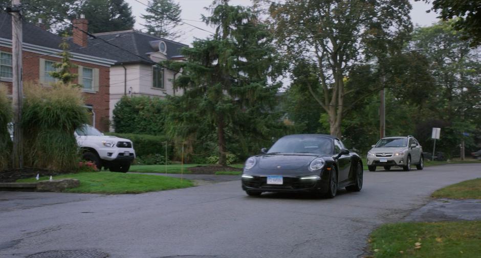 Emily and Stephanie drive their cars down the street towards Emily's home.