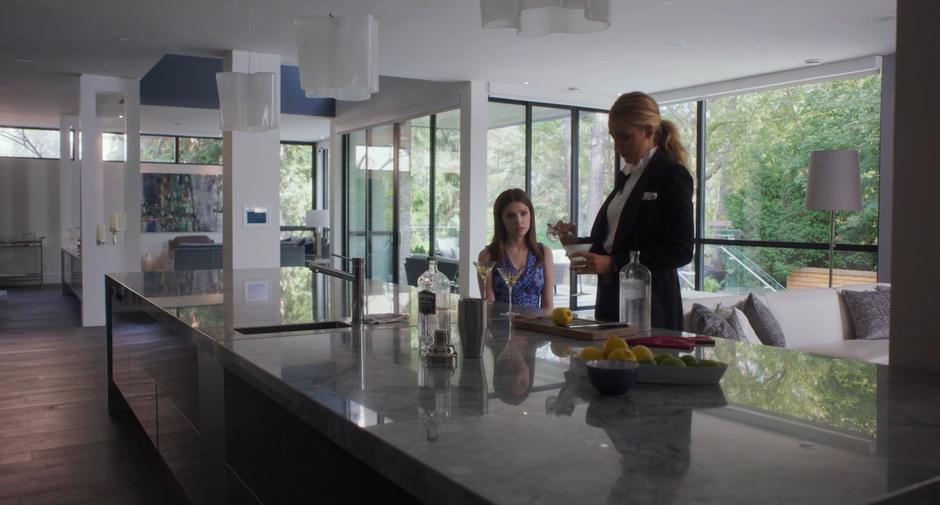 Emily makes another martini for Stephanie while they talk in the kitchen.