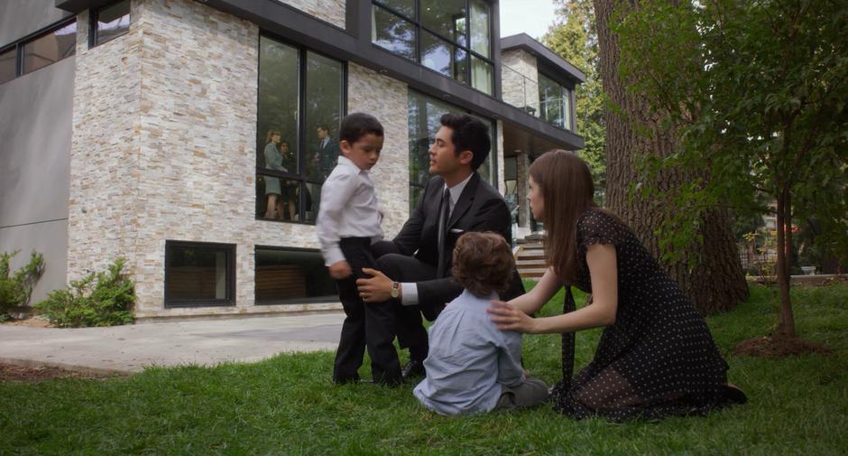 Sean and Stephanie stop their boys from fighting while the other parents from school watch through the window during the wake.