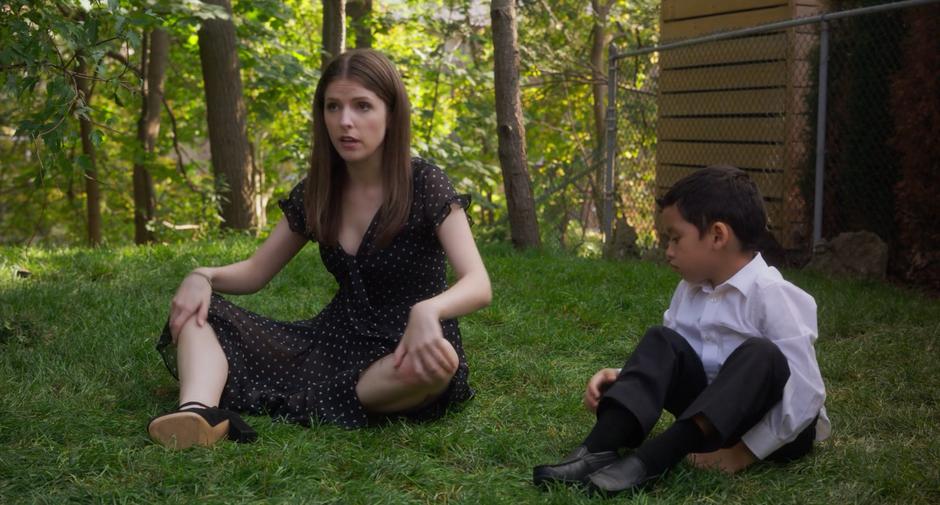 Stephanie sits on the grass next to Miles after the fight.