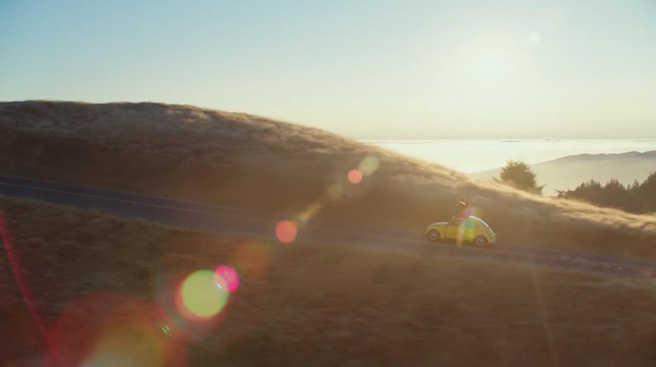 Bumblebee drives down the road while Charlie and Memo stand up through the sunroof.