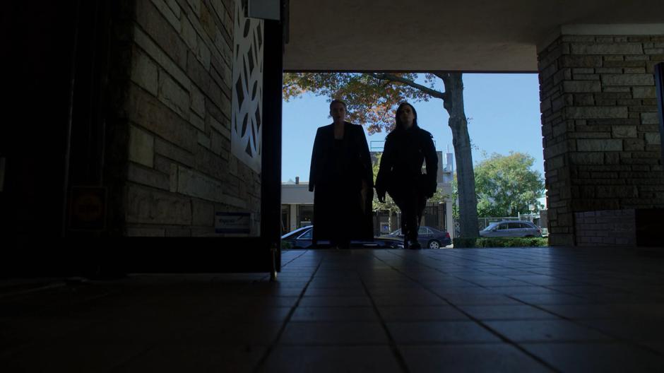 Trish and Jessica walk up the steps to the front door for the funeral.