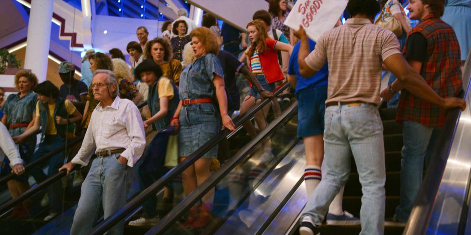 Mike, Lucas, Max, and Will push their way through the crowd down the escalator.