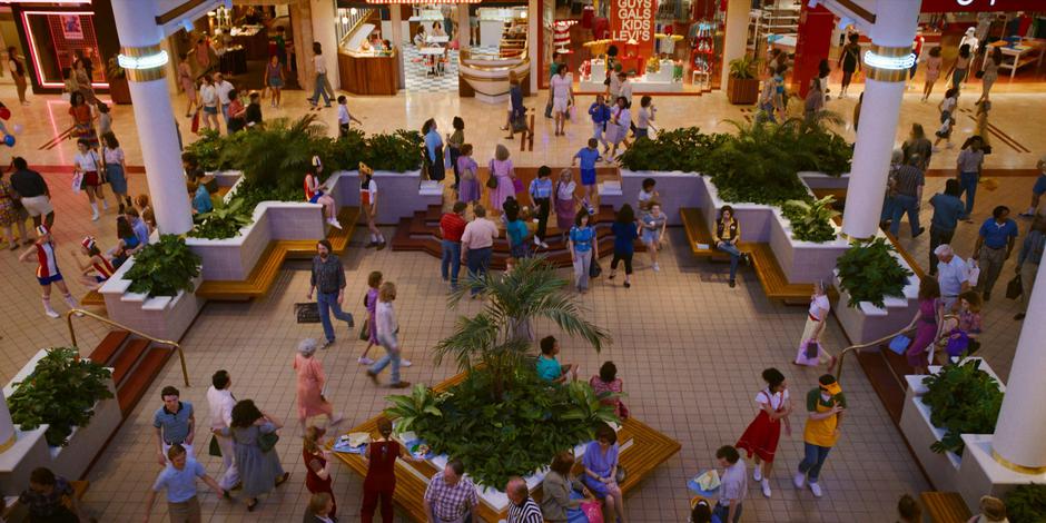 People mill around inside the busy mall.