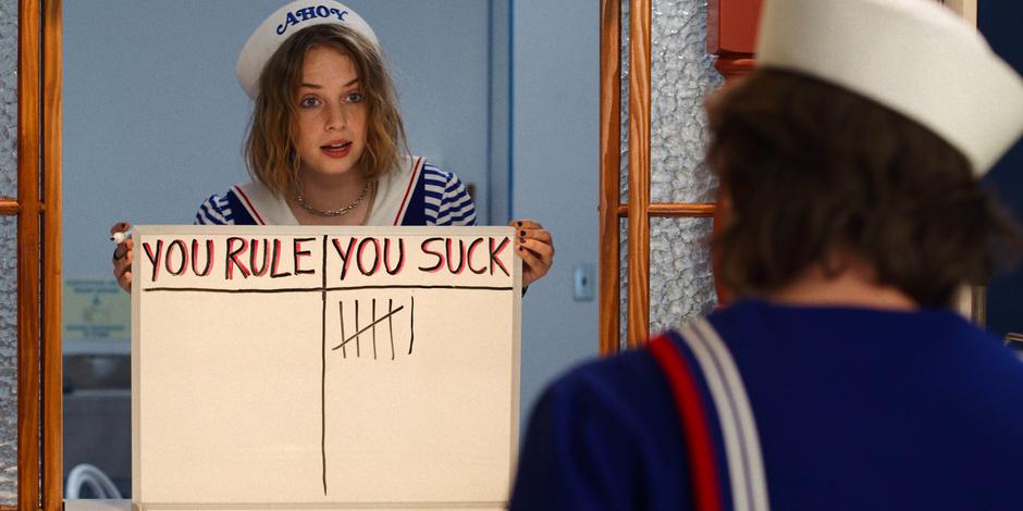 Robin shows Steve a whiteboard after marking another slash under the "You Suck" column.