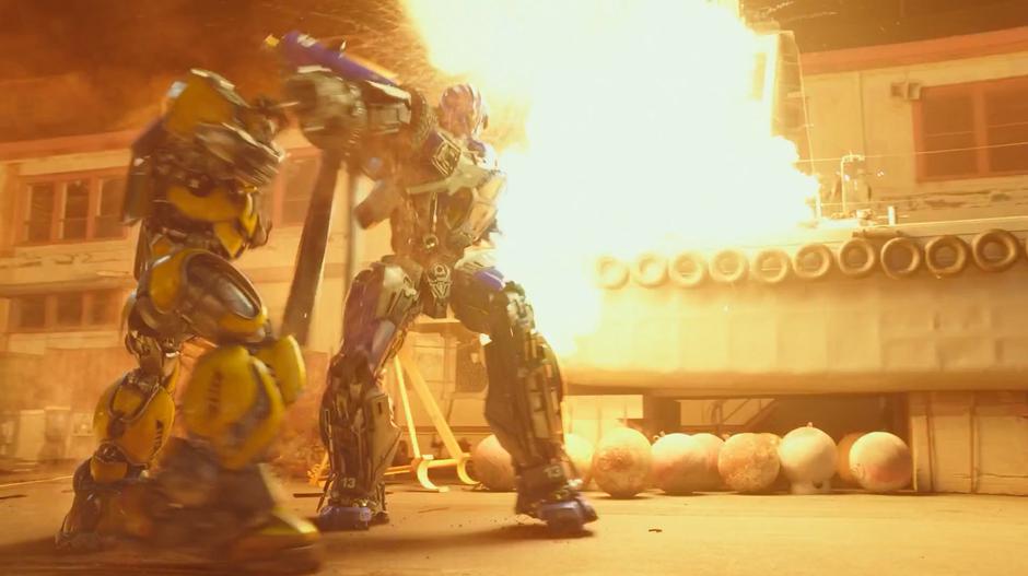 Bumblebee and Dropkick fight as an explosion goes off behind them.