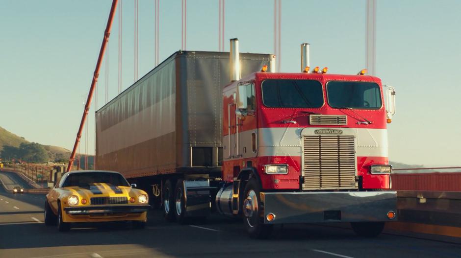 Bumblebee drives across the bridge in his Camaro form past a familiar-looking truck.