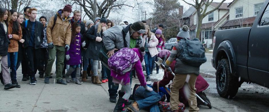 Pedro, Darla, Mary, and Eugene circle around Freddy who is on the ground after being attacked by the two bullies.