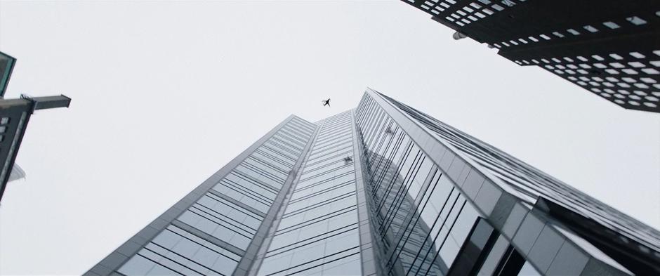 Billy jumps up towards the building but not high enough to get over the top.