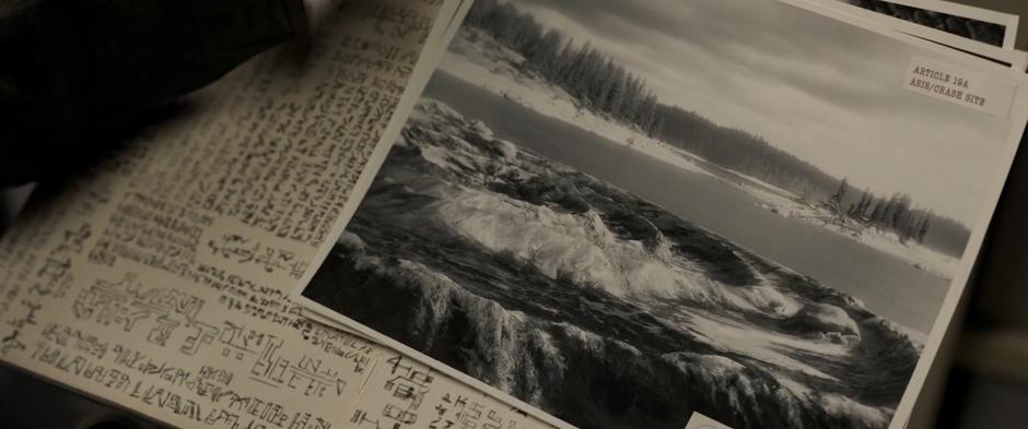 Vers looks at a photograph of the crater in Dr. Lawson's file.