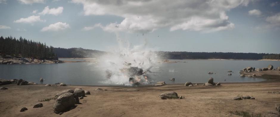 The experimental aircraft crashes into the water just short of the shore.