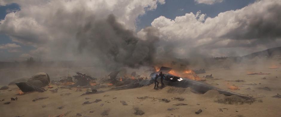 Carol helps Dr. Lawson climb out of the crashed experimental craft.