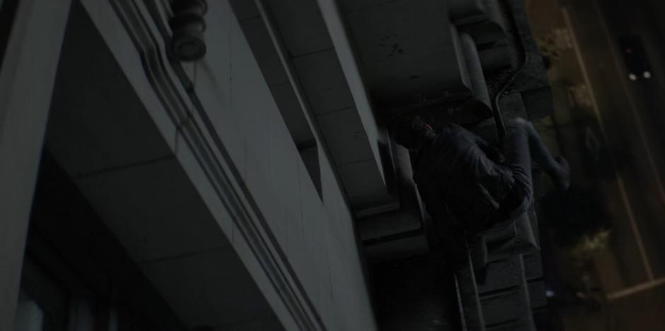 Kate climbs up onto the stone ledge near the window.