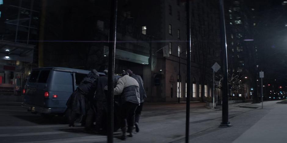 The masked attackers shove Sophie into their van.