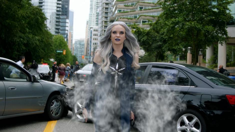 Frost walks down the street after saving someone with her powers.