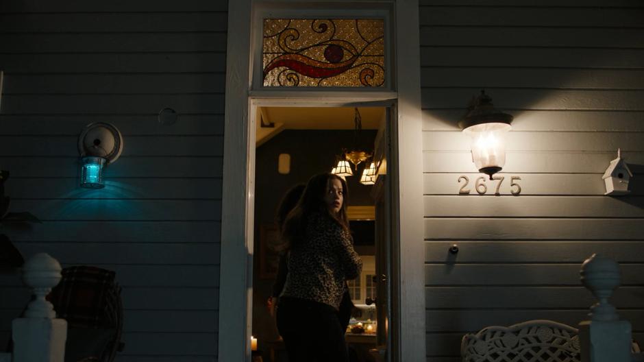 Maggie glances over her shoulder as she follows hers sisters into the B&B.