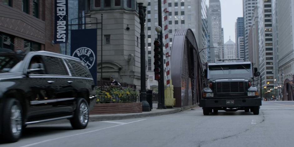 The Crows Security armored truck drives off the other side of the bridge.