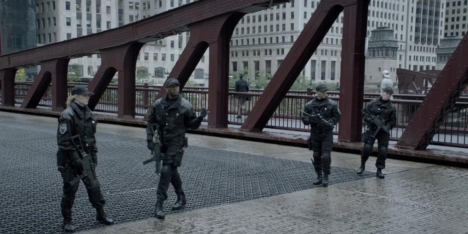 Four Crows Security guards step aside to let the armored truck pass.